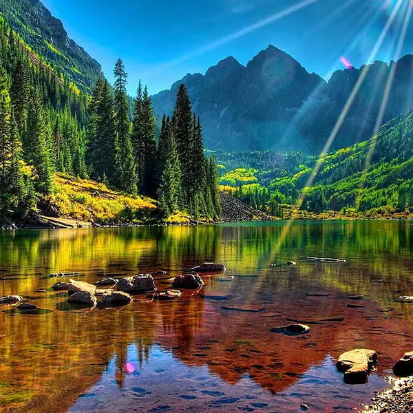 Maroon Lake captured in a stunning photograph by Jimmy Kirk, highlighting its calm waters and picturesque mountain backdrop.